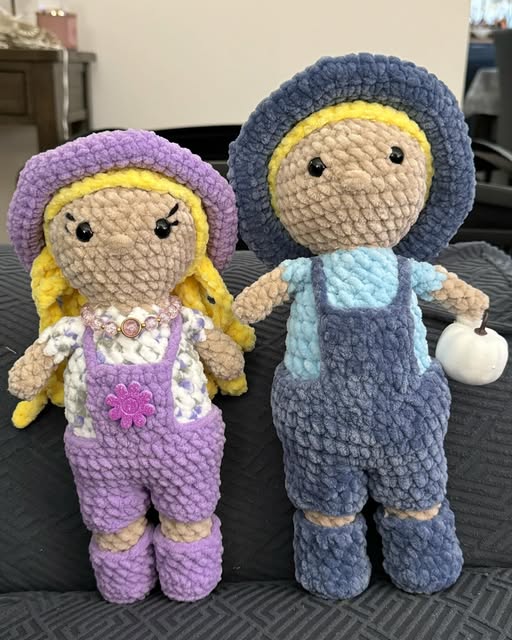 Two crochet dolls in purple and blue outfits